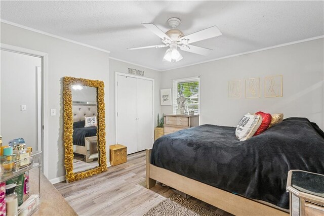  - bedroom featuring ornamental molding, light wood finished floors, and a textured ceiling