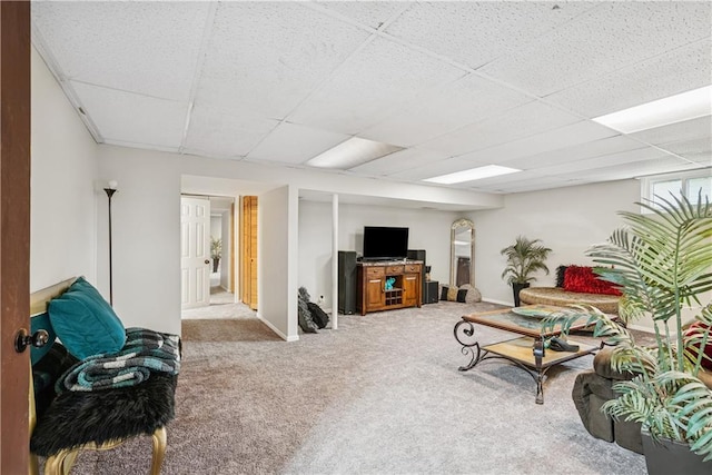  - living area featuring baseboards, a paneled ceiling, and carpet