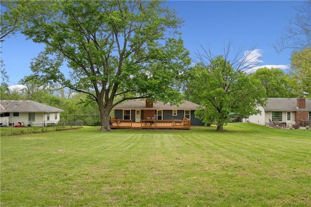  - view of yard with fence and a wooden deck