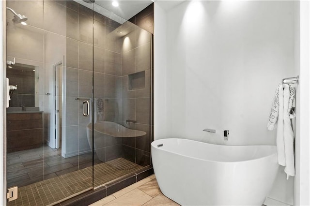 4727 Liberty St, Kansas City, MO 64112 - full bath featuring a stall shower, a soaking tub, and vanity