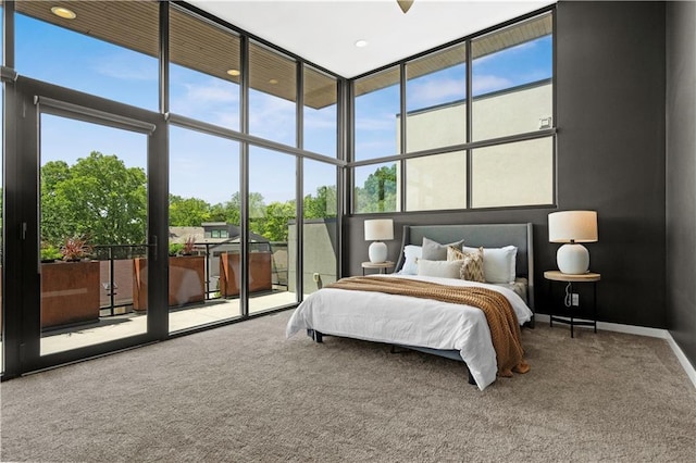 4727 Liberty St, Kansas City, MO 64112 - carpeted bedroom featuring access to outside, a towering ceiling, multiple windows, floor to ceiling windows, and baseboards