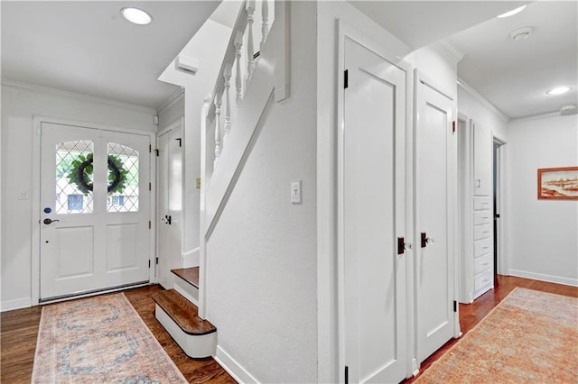 entryway with crown molding, wood finished floors, stairs, baseboards, and recessed lighting