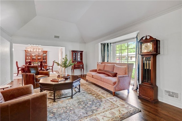 living room featuring lofted ceiling, a chandelier, wood finished floors, baseboards, and ornamental molding