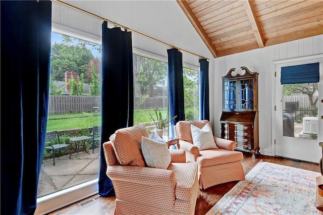 sunroom / solarium with wood ceiling, plenty of natural light, and wood finished floors