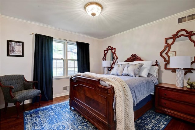 bedroom with wood finished floors, ornamental molding, and baseboards