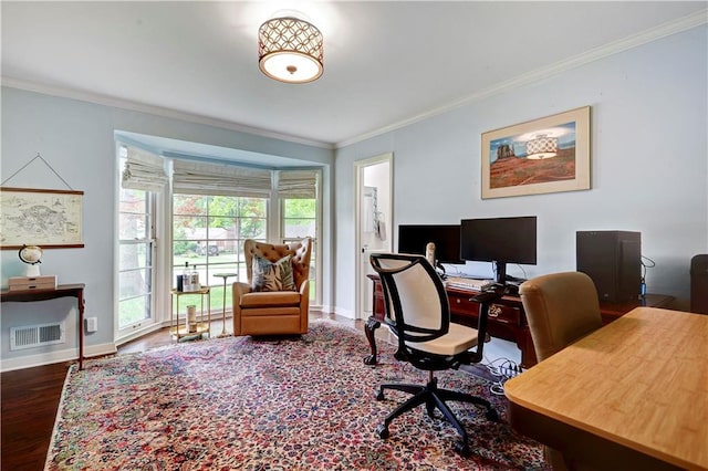 office area with crown molding, wood finished floors, and baseboards