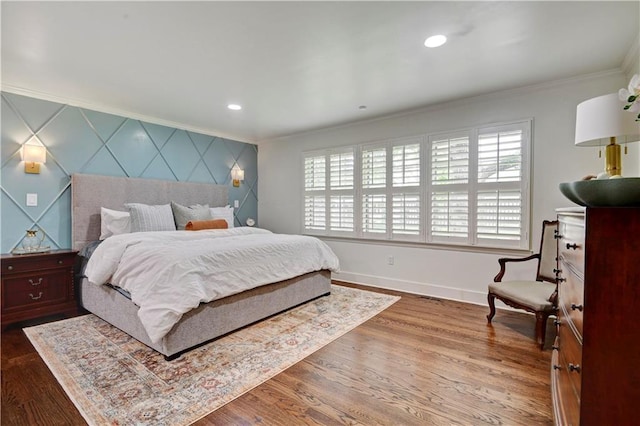 bedroom featuring crown molding, multiple windows, baseboards, wood finished floors, and recessed lighting