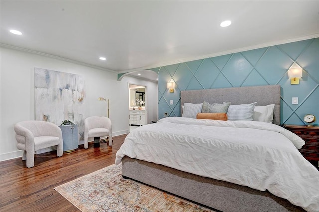 bedroom with crown molding, arched walkways, baseboards, wood finished floors, and recessed lighting