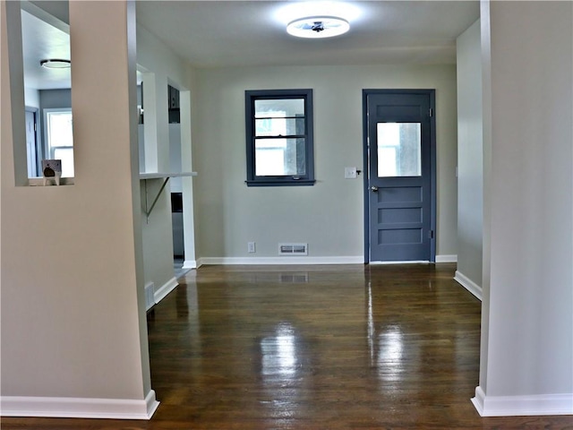 3417 Jackson Ave, Kansas City, MO 64128 - entryway featuring baseboards, visible vents, and wood finished floors