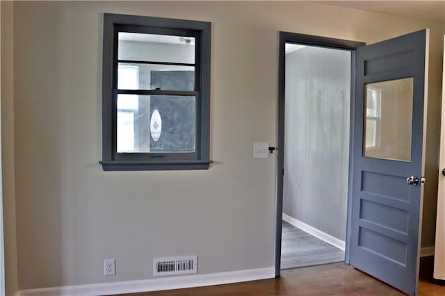 3417 Jackson Ave, Kansas City, MO 64128 - foyer featuring baseboards, visible vents, and wood finished floors