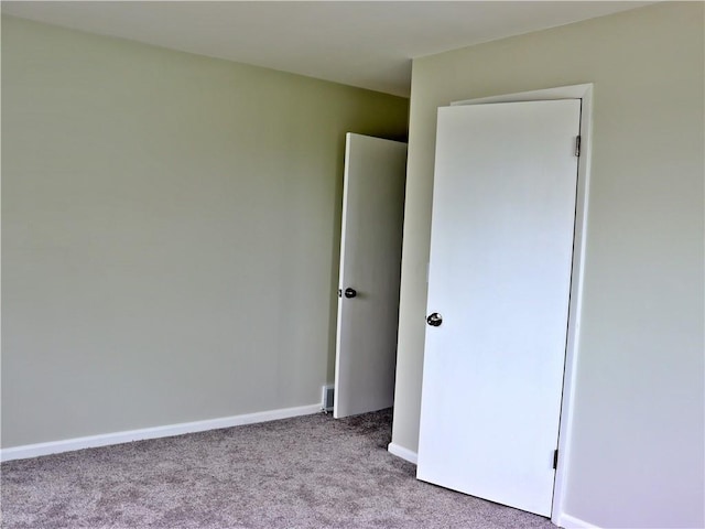 3417 Jackson Ave, Kansas City, MO 64128 - unfurnished bedroom featuring carpet floors and baseboards