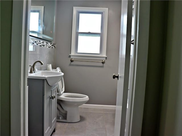 3417 Jackson Ave, Kansas City, MO 64128 - half bath featuring vanity, baseboards, toilet, and marble finish floor