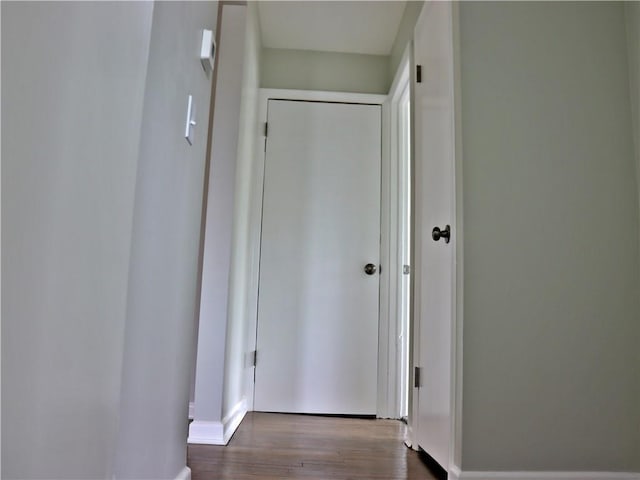 3417 Jackson Ave, Kansas City, MO 64128 - hallway featuring dark wood-style flooring and baseboards
