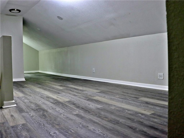 3417 Jackson Ave, Kansas City, MO 64128 - bonus room featuring wood finished floors, baseboards, and lofted ceiling