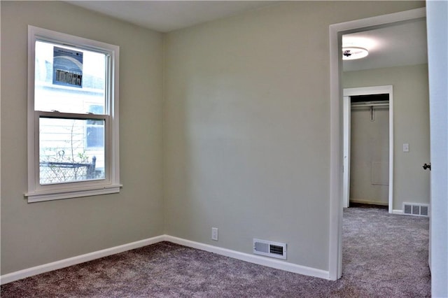 3417 Jackson Ave, Kansas City, MO 64128 - carpeted empty room with a healthy amount of sunlight, baseboards, and visible vents