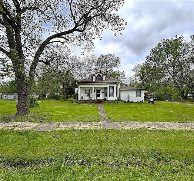 109 S State Route F, Garden City, MO 64747 - view of front of house with covered porch and a front lawn