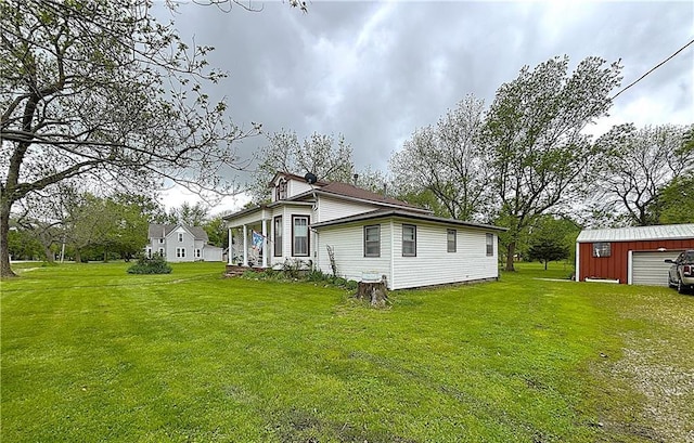109 S State Route F, Garden City, MO 64747 - view of home's exterior with a yard, an outdoor structure, and a garage