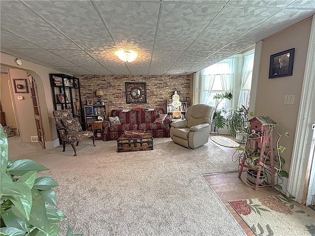 109 S State Route F, Garden City, MO 64747 - carpeted living room featuring arched walkways and brick wall
