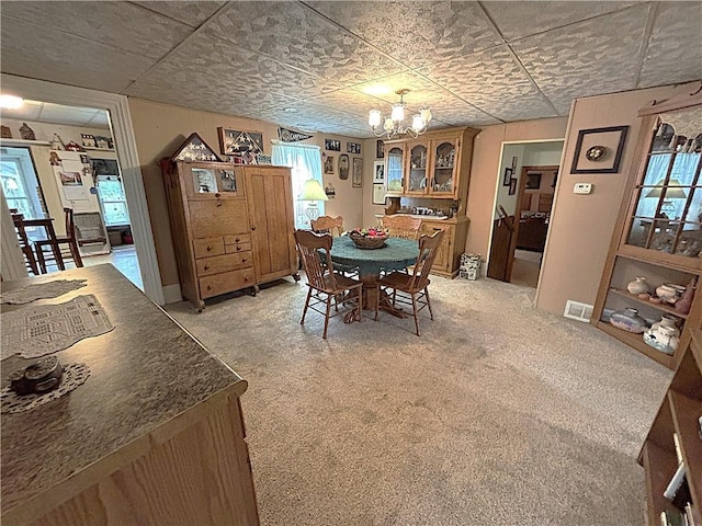 109 S State Route F, Garden City, MO 64747 - dining area featuring plenty of natural light, a notable chandelier, light colored carpet, and visible vents
