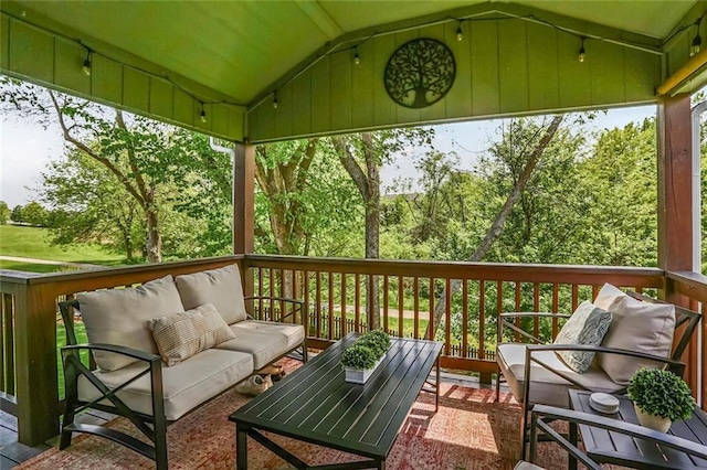 sunroom / solarium with lofted ceiling and an outdoor hangout area