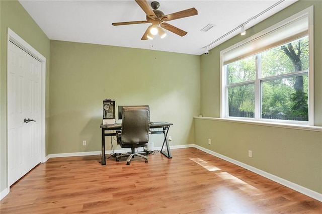 office space featuring ceiling fan, wood finished floors, and baseboards
