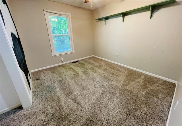 spare room featuring visible vents, carpet, ceiling fan, and baseboards