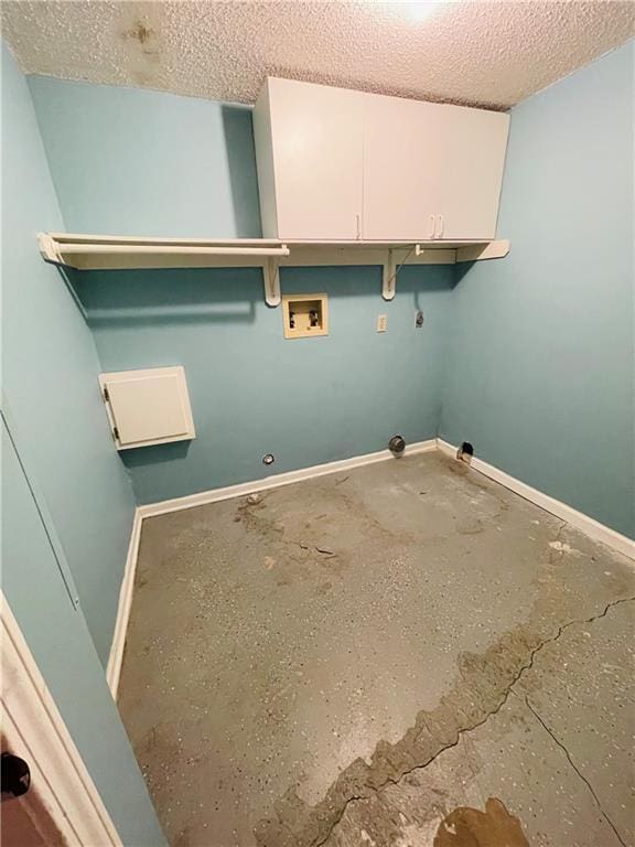 washroom featuring a textured ceiling, washer hookup, baseboards, and gas dryer hookup