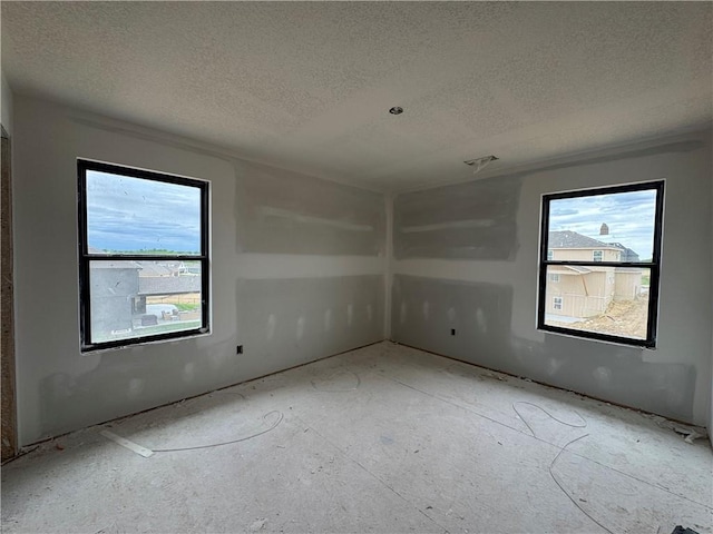 13610 NE 114th Pl, Kearney, MO 64060 - unfurnished room featuring plenty of natural light and a textured ceiling