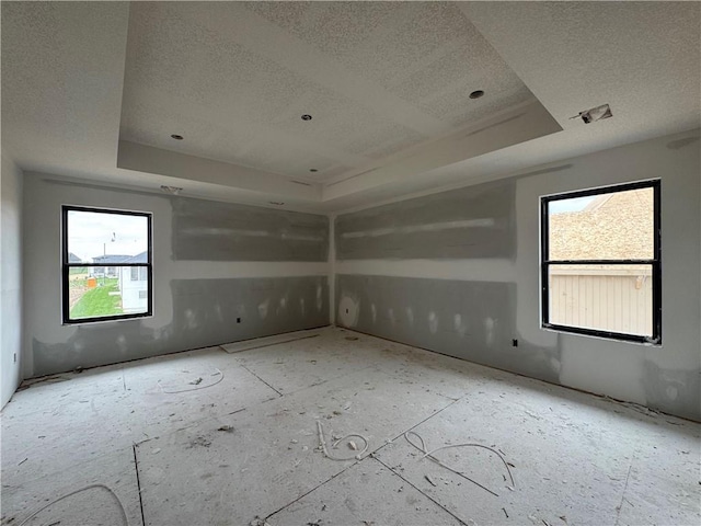 13610 NE 114th Pl, Kearney, MO 64060 - unfurnished room with a raised ceiling, a textured ceiling, and healthy amount of natural light