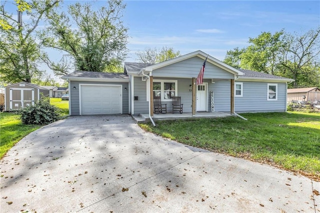 view of front of home featuring covered porch, driveway, a front yard, a storage shed, and a garage