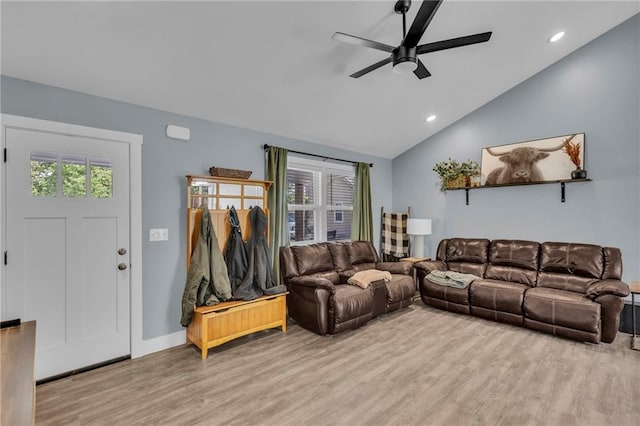 living room with a healthy amount of sunlight, ceiling fan, light wood finished floors, and lofted ceiling