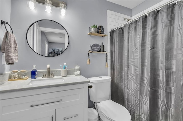 bathroom with vanity, curtained shower, and toilet