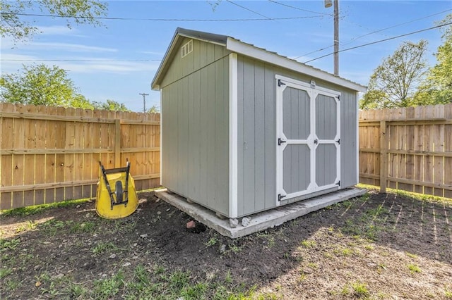 view of shed with a fenced backyard