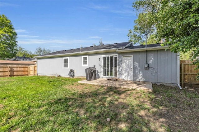 back of property featuring a lawn, a fenced backyard, and a patio area