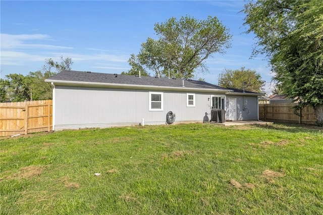 rear view of property with a yard, a patio, and a fenced backyard
