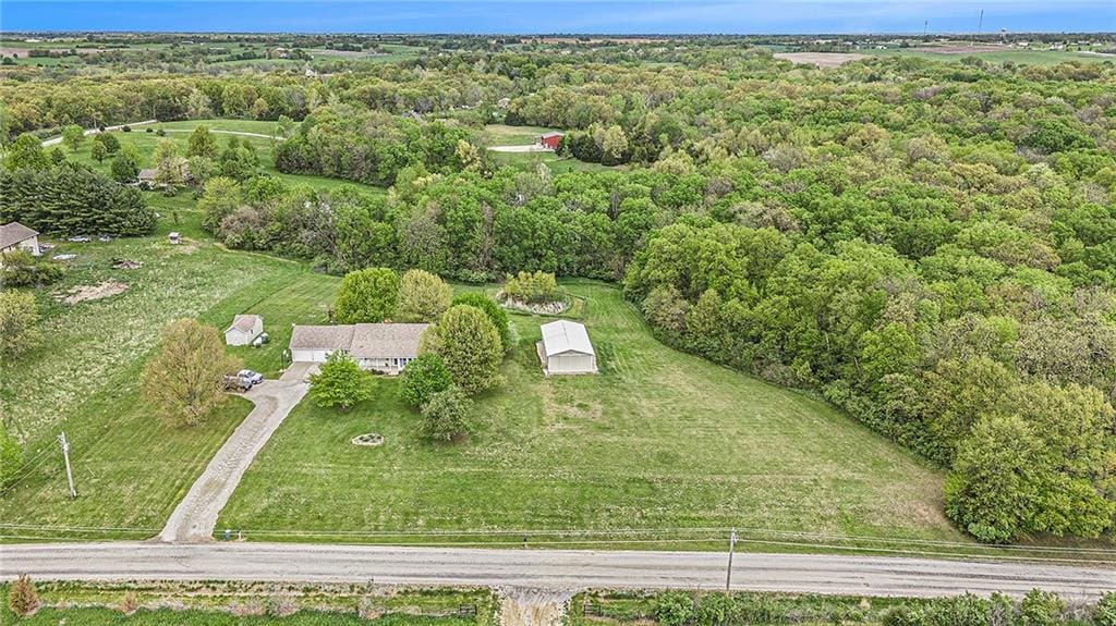 aerial view of property's location with a heavily wooded area