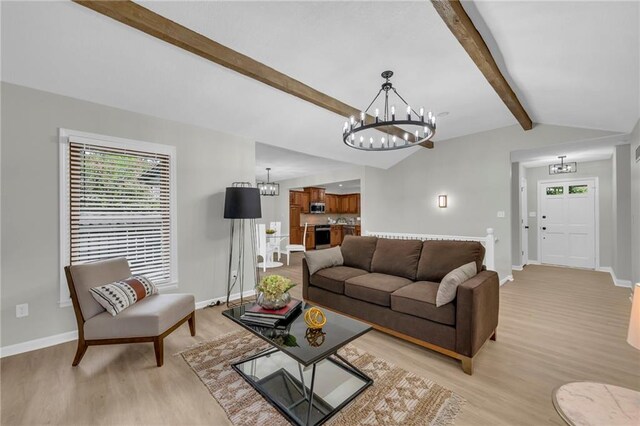 213 Lake Village Blvd, Blue Springs, MO 64014 - living area featuring baseboards, a wealth of natural light, light wood-type flooring, and a chandelier