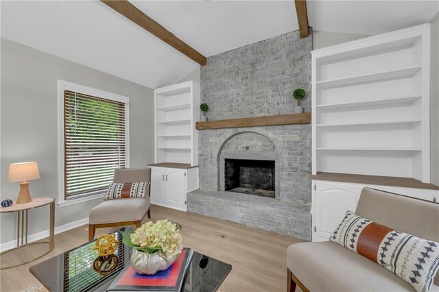 213 Lake Village Blvd, Blue Springs, MO 64014 - living area with lofted ceiling with beams, a fireplace, built in features, baseboards, and wood finished floors