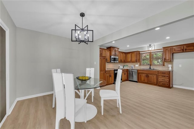 213 Lake Village Blvd, Blue Springs, MO 64014 - dining space featuring recessed lighting, baseboards, a notable chandelier, and light wood finished floors