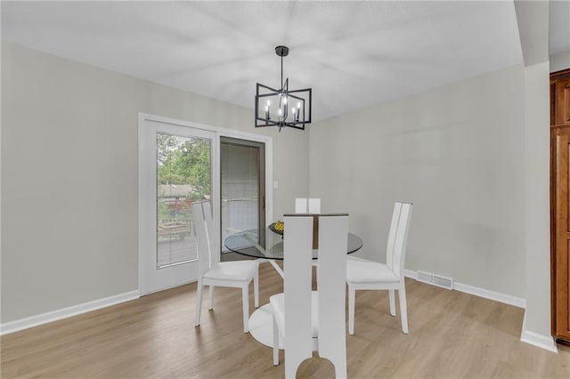 213 Lake Village Blvd, Blue Springs, MO 64014 - dining space with baseboards, light wood finished floors, a notable chandelier, and visible vents