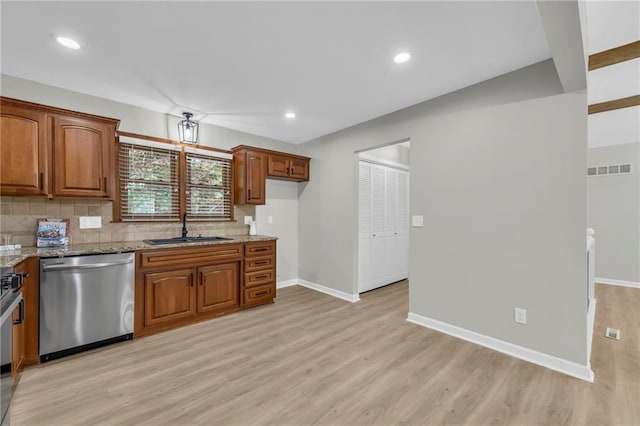 213 Lake Village Blvd, Blue Springs, MO 64014 - kitchen with stainless steel dishwasher, light stone countertops, baseboards, and light wood-style flooring