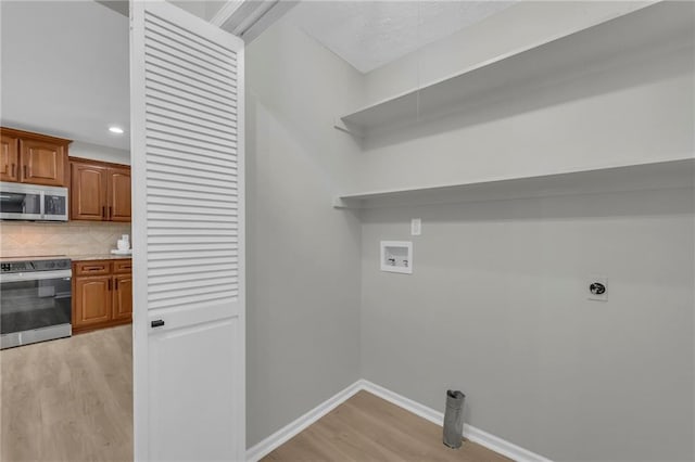 213 Lake Village Blvd, Blue Springs, MO 64014 - laundry room featuring washer hookup, laundry area, electric dryer hookup, light wood finished floors, and recessed lighting