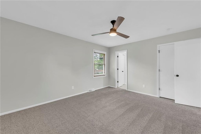 213 Lake Village Blvd, Blue Springs, MO 64014 - unfurnished bedroom featuring carpet floors, baseboards, visible vents, and ceiling fan