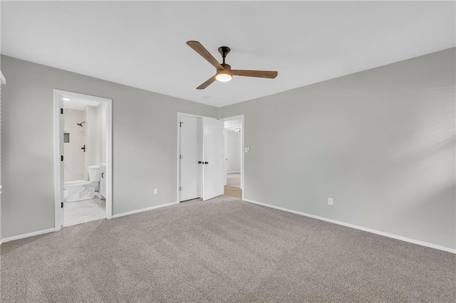 213 Lake Village Blvd, Blue Springs, MO 64014 - unfurnished bedroom with baseboards, carpet, a ceiling fan, and connected bathroom