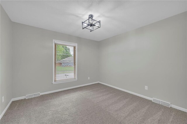 213 Lake Village Blvd, Blue Springs, MO 64014 - carpeted spare room with visible vents, baseboards, and an inviting chandelier