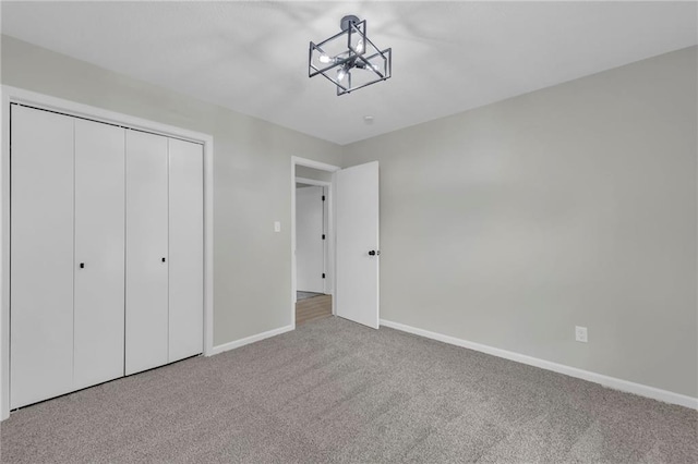 213 Lake Village Blvd, Blue Springs, MO 64014 - unfurnished bedroom featuring carpet floors, baseboards, a chandelier, and a closet