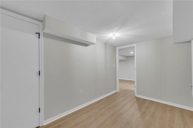 213 Lake Village Blvd, Blue Springs, MO 64014 - finished below grade area with baseboards, a textured ceiling, and light wood finished floors