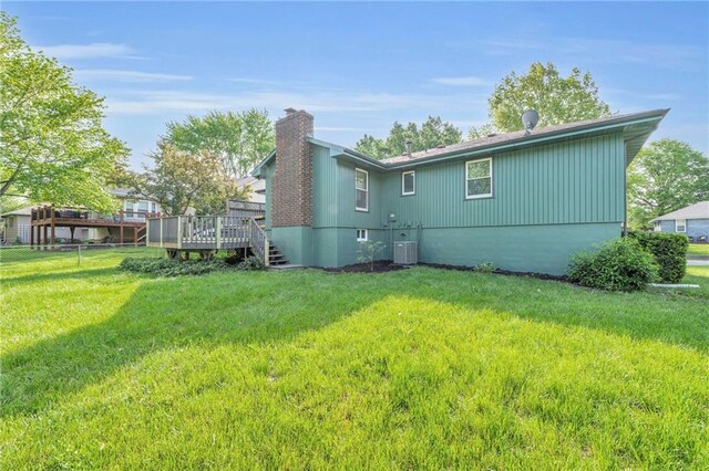 213 Lake Village Blvd, Blue Springs, MO 64014 - rear view of property featuring a lawn, a chimney, and a deck