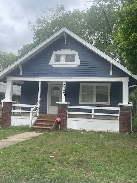 2120 68th Ter, Kansas City, MO 64132 - bungalow-style house with a porch and a front lawn