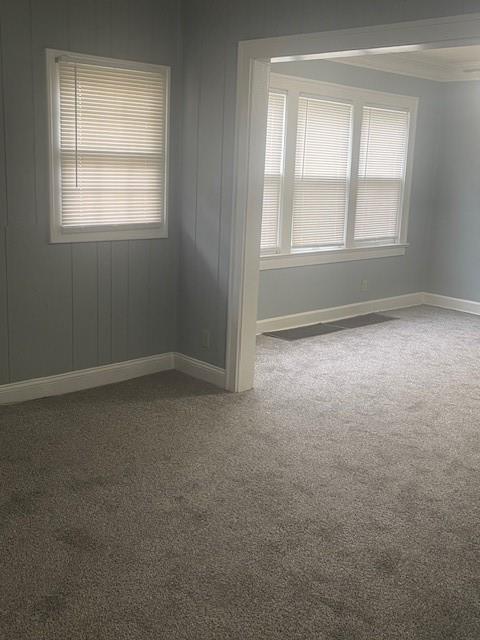 2120 68th Ter, Kansas City, MO 64132 - carpeted empty room with baseboards and ornamental molding